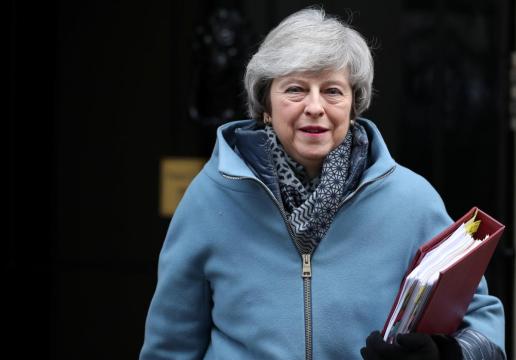 May back in Brussels, hit by defections over Brexit