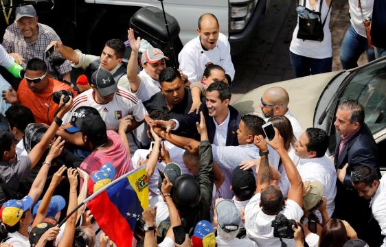 Venezuela's Guaido returns home in affront to Maduro