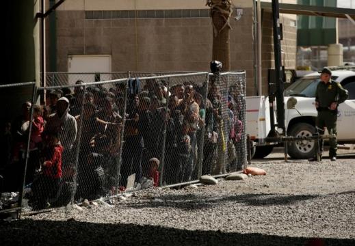Migrants held in El Paso, Texas, enclosure as surge overwhelms city