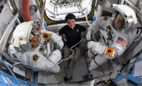 Astronauts (male and female) hook up batteries during not-so-historic spacewalk