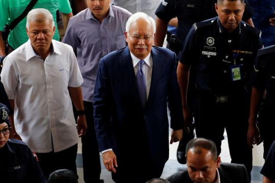 Malaysia's former leader Najib in the dock as graft trial begins