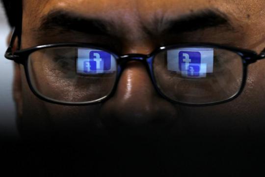 Britain plans social media watchdog to battle harmful content