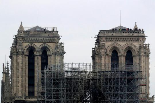 Notre-Dame smolders as investigation begins