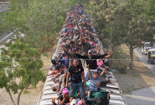 Hundreds of migrants in southern Mexico board 'The Beast' heading north
