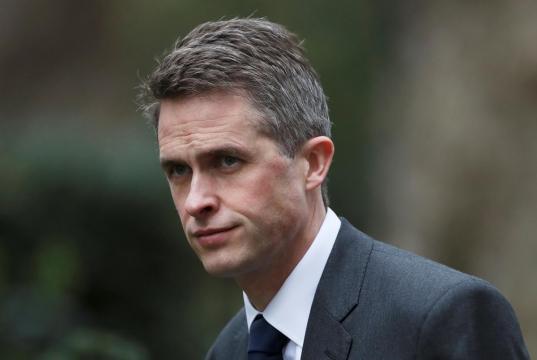 UK's May fires defence secretary over Huawei leak
