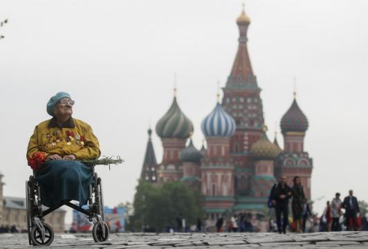 Putin, battling ratings slump, reviews Red Square military parade