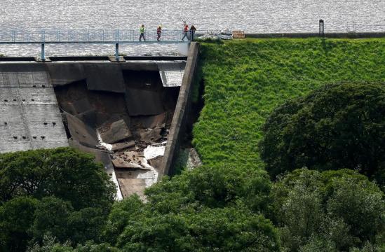 Derbyshire town evacuated after water cascades through damaged dam
