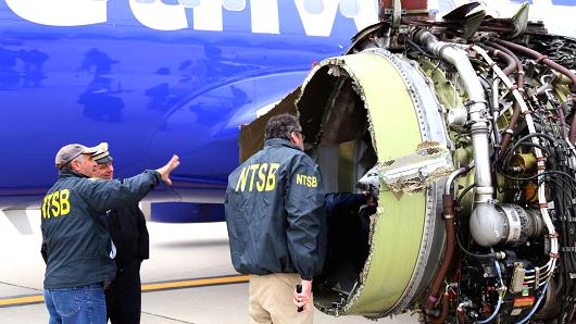 U.S. NTSB investigators are on scene examining damage to the engine of the Southwest Airlines plane in this image released from Philadelphia, Pennsylvania, U.S., April 17, 2018.