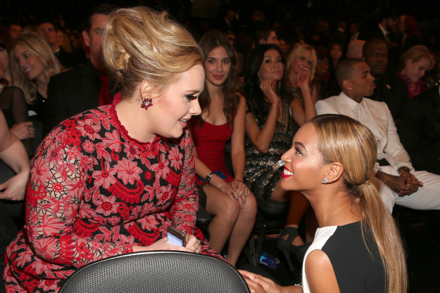 Adele and Beyoncé chit-chatted at the Grammys, and TBH we are all the woman in the red dress in the background excitedly watching every second of the conversation.