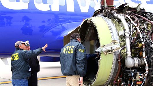 U.S. NTSB investigators are on scene examining damage to the engine of the Southwest Airlines plane in this image released from Philadelphia, Pennsylvania, U.S., April 17, 2018.