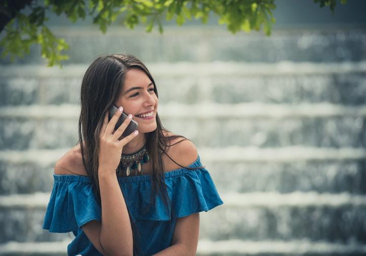 woman-talks-to-family-on-phone-1024x718.jpg