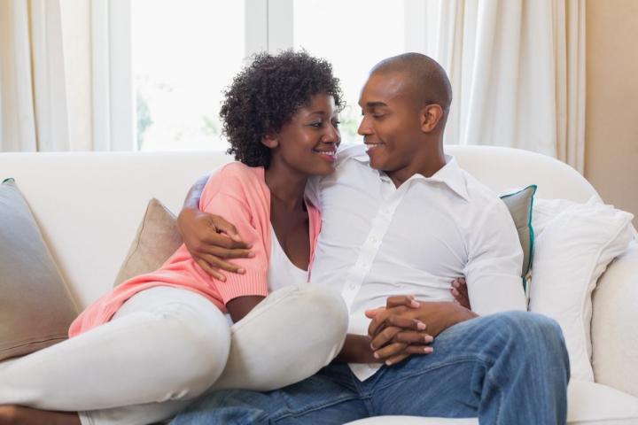 Couple-Holding-Hands-on-Couch-1024x683.jpg