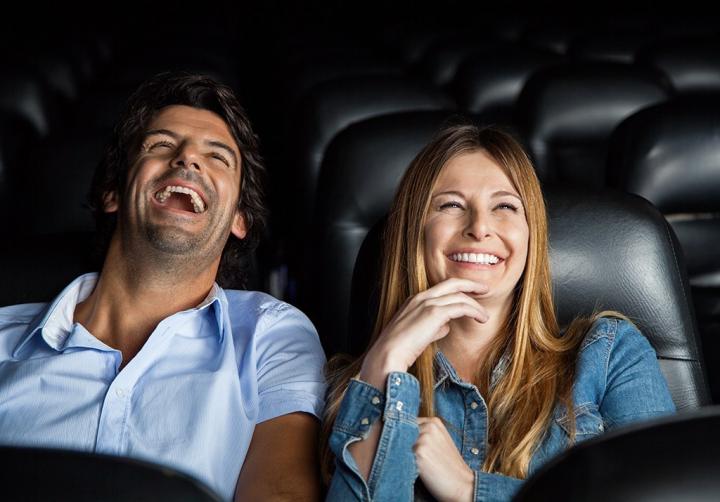 couple-laughing-in-movie-theater.jpg?resize=1024%2C715&ssl=1