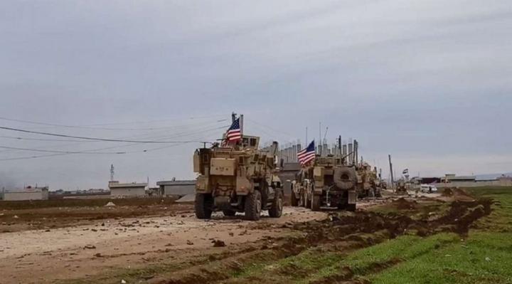 A convoy of U.S military vehicles moves in the village of Khirbet Amo, near Qamishli, Syria, Feb. 12, 2020.Sana via Reuters