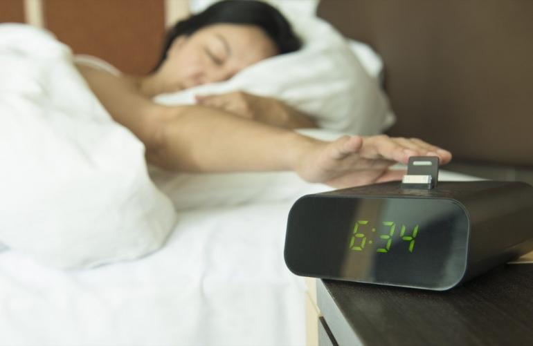 woman-in-bed-turning-off-alarm-clock-1024x667.jpg