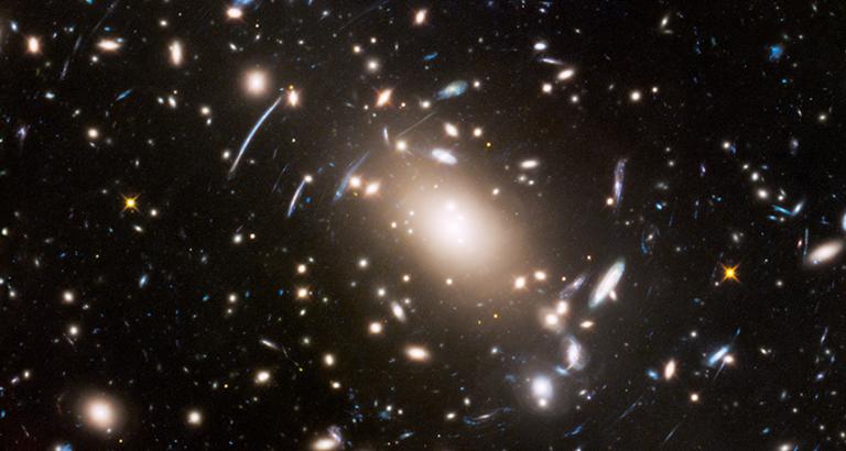 A faint glow found between galaxies could be a beacon for dark matter