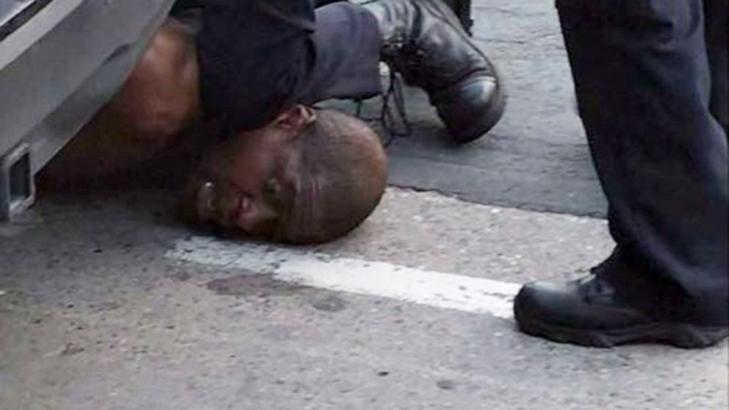 Protesters clash with police following death of black man seen pinned down in video