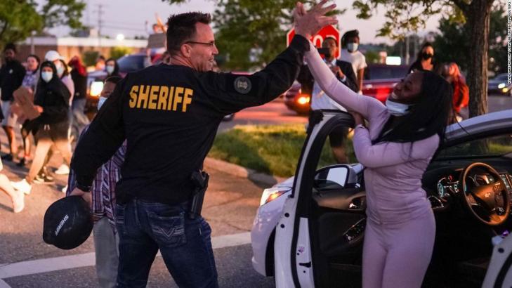 Sheriff lowered his baton to listen to protesters. They said 'walk with us,' so he did