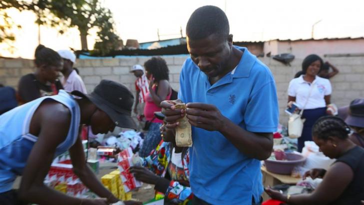 Zimbabweans mend shabby dollar notes amid economic crisis