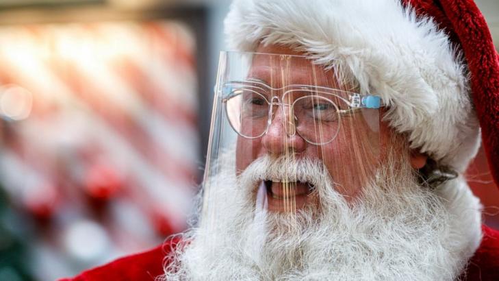 Here comes Santa Claus - with face masks and plexiglass