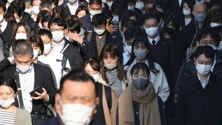 Japan's daily virus cases surge past previous record high