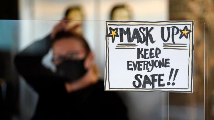 Keep the mask: A vaccine won't end the US crisis right away