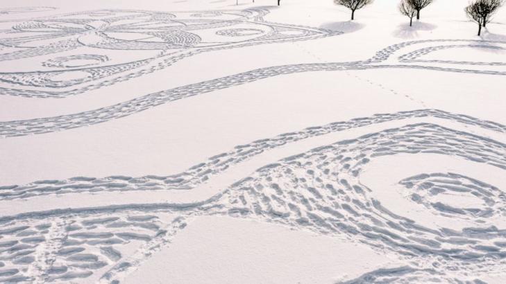 Finns in snowshoes create temporary artwork on golf course