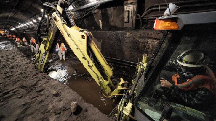 In a leaky underwater rail tunnel, workers race against time