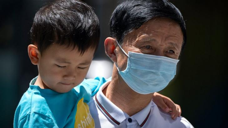 Chinese city locks down neighborhood after virus upsurge