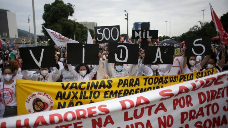 The Latest: Protests decry Brazil policies as toll tops 500K