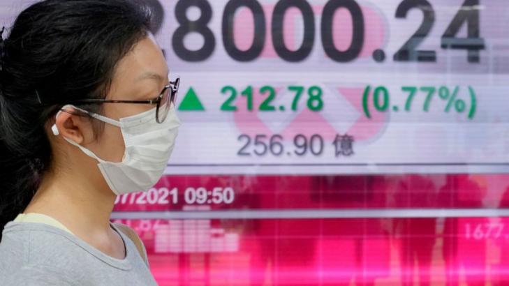 Asian shares trading mixed as China reports growth slowed