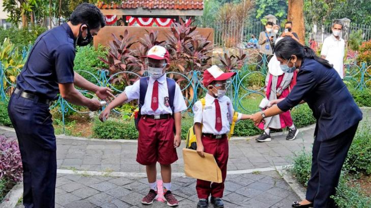 Some Indonesian students return to schools, at a distance