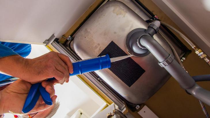 How to Fill Holes Around the Pipes Under Your Kitchen Sink