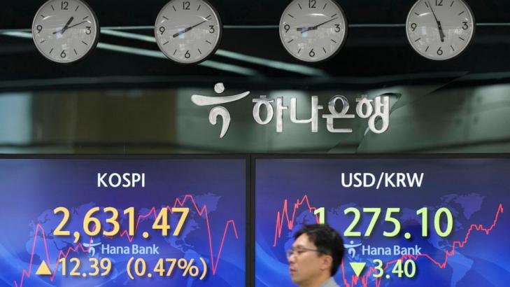 Stock market today: Asia shares mixed after Fed holds rates steady and hints of hikes ahead