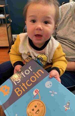 Kid-with-bitcoin-book-e1688411304300.jpg