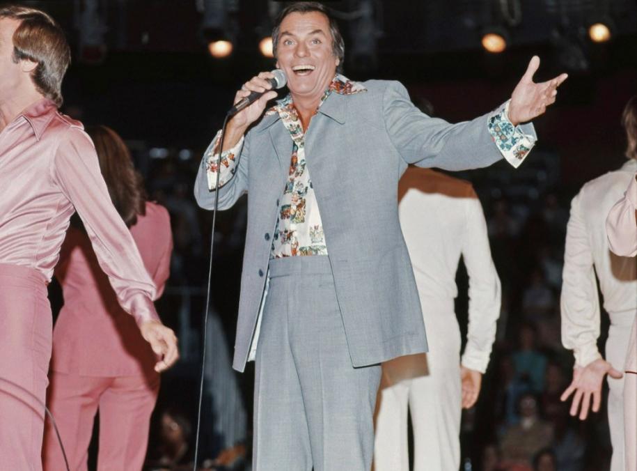 man-wearing-a-leisure-suit-and-holding-a-microphone.jpg?resize=1024%2C757&ssl=1